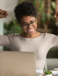 Photo of woman smiling with arms in the air