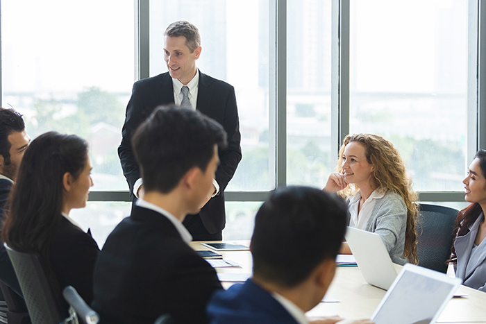 Two people sitting at a conference table in an office conducting an interview.