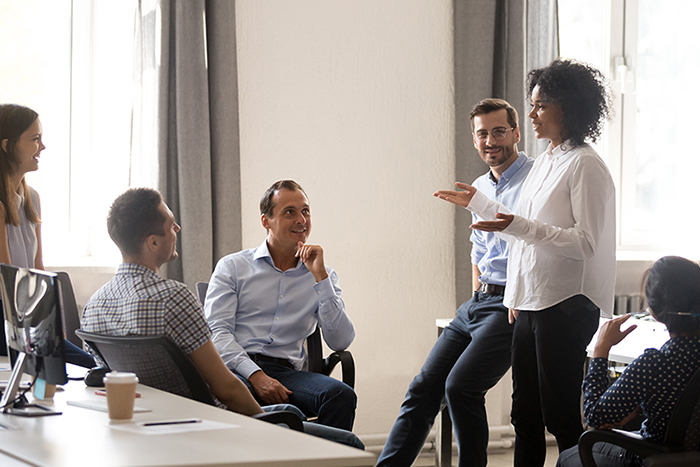 Two people sitting at a conference table in an office conducting an interview.