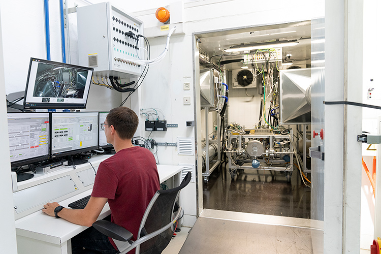 Person using testing equipment in a manufacturing facility