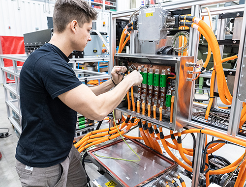 Person working on testing equipment in test lab