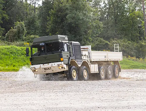 Truck driving along a gravel road performing tests
