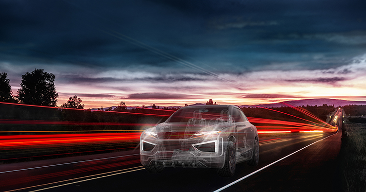 Ghosted vehicle driving along a dark road with lights running along the road