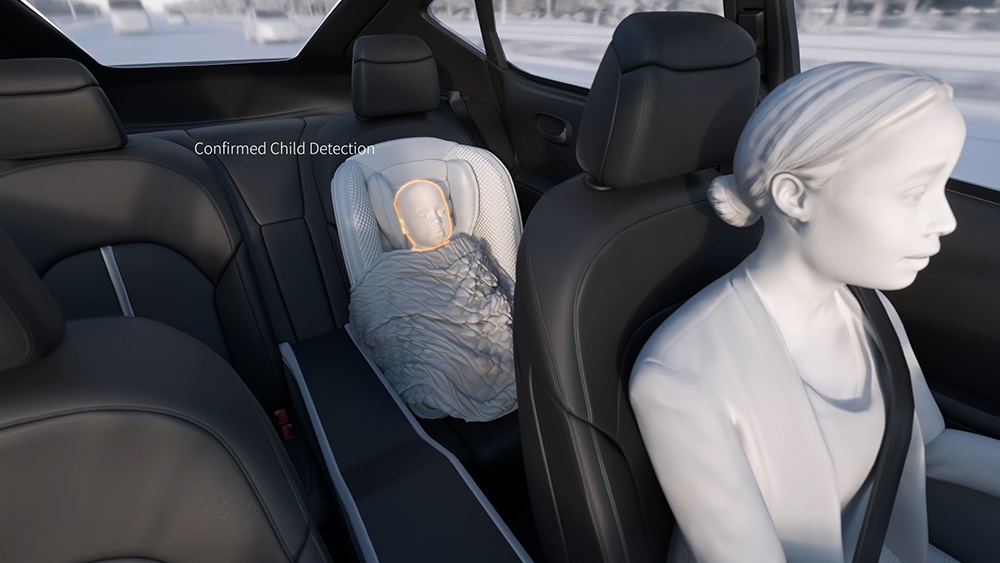 Animation of person driving a vehicle and a baby is detected in the back seat using occupant monitoring technology