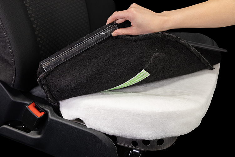 Black car seat with the seat cover lifted showing the foam made out of recycled material