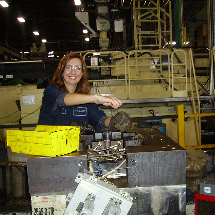 Adriana Huntington smiling and working in a manufacturing facility