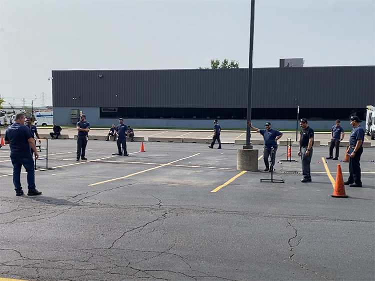 Magna Sterling Heights employees playing games in the parking lot of the facility.