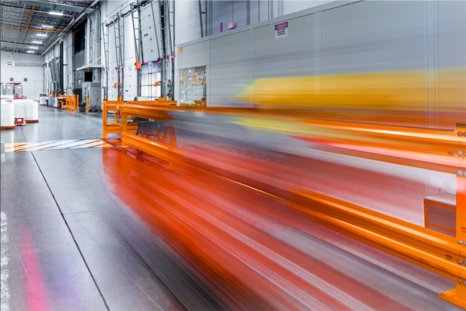Inside a manufacturing facility with streaking yellow and orange lines
