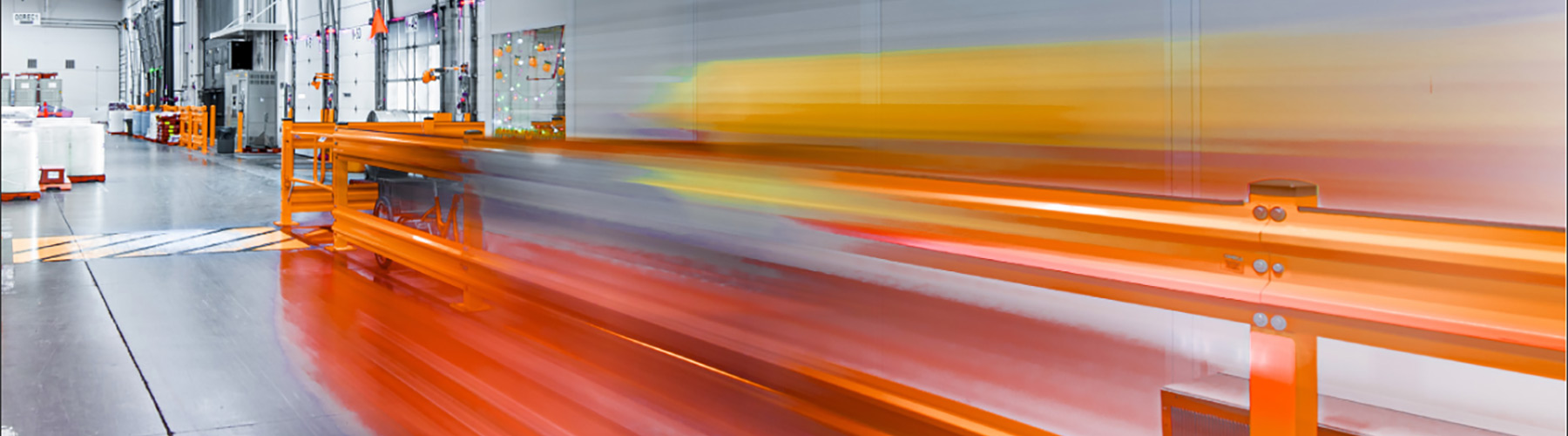 Inside a manufacturing facility with streaking yellow and orange lines