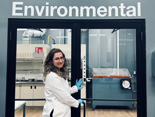 Scientist standing in front of the Environmental Lab entrance