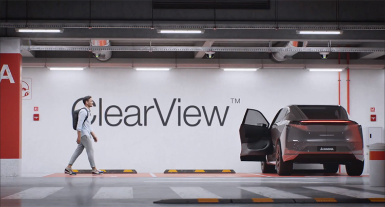 Person walking to a vehicle in an underground garage with an open door with the word ClearView on the wall